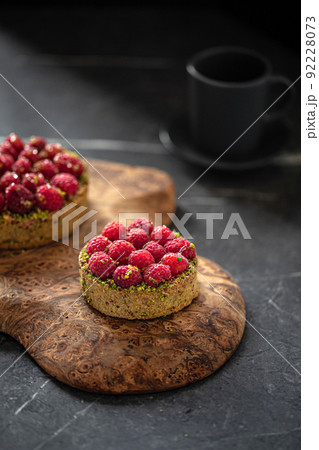 Two delicious raspberry tartlets with pistachios Two delicious raspberry tartlets with pistachios 92228073