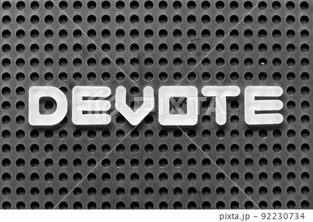 White alphabet letter in word devote on black pegboard background White alphabet letter in word devote on black pegboard background 92230734