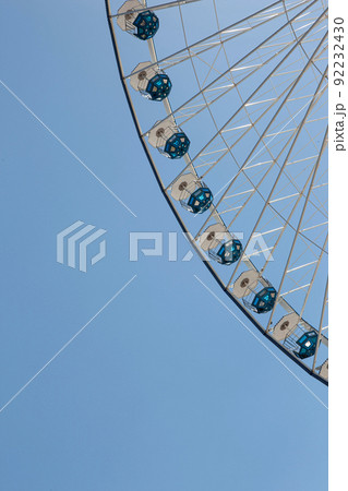 Big wheel and blue sky on background Big wheel and blue sky on background 92232430