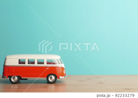 Car travel concept background. Toy retro car on an empty blue background. 92233279