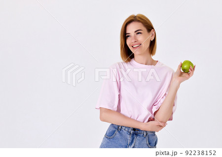 girl holding green apple isolated on white background 92238152