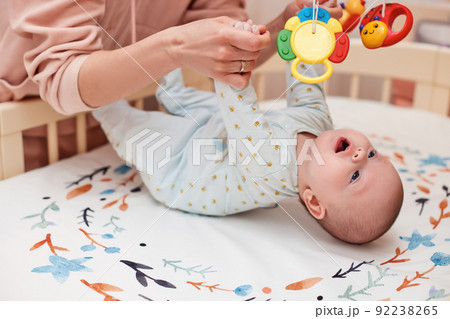 Baby massage. Mother doing gymnastics with newborn child 92238265