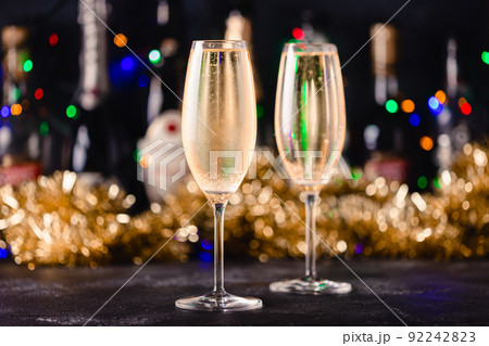 Champagne glasses on a dark background. 92242823