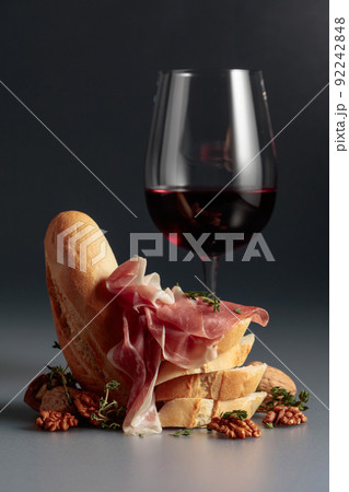 Prosciutto with red wine, baguette, walnuts, and thyme. Prosciutto with red wine, baguette, walnuts, and thyme. 92242848