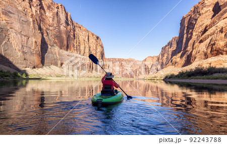 Adventurous Woman on a Kayak paddling in Colorado River. Glen Canyon, Arizona 92243788