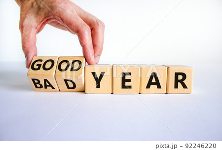 Bad or good year concept. Businessman turns cubes and changes words 'bad year' to 'good year'. Beautiful white background. Business and bad or good year concept. Copy space. 92246220