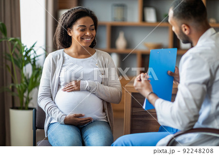 Pregnant black woman visiting doctor at private clinic 92248208