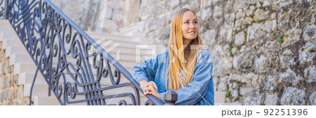 Young woman tourist in the old town of Budva. Travel to Montenegro concept BANNER, LONG FORMAT 92251396