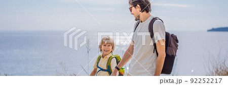 Dad and son tourists walks along the coast of Budva in Montenegro BANNER, LONG FORMAT 92252217