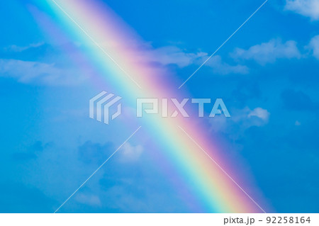 雨が上がる青空にかかる虹 たすき掛けにクローズアップ　高彩度 92258164