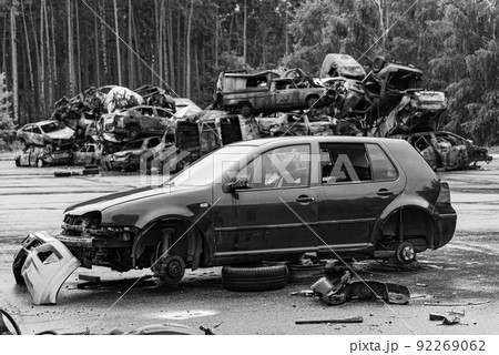 Dump of war-destroyed cars in Ukraine, black and white photo 92269062