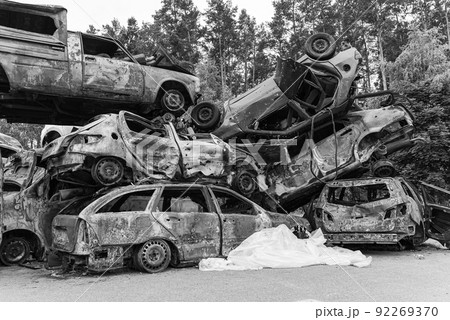 Shot and burned cars during the war in Ukraine, black and white photo Shot and burned cars during the war in Ukraine, black and white photo 92269370