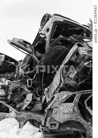 Dump of war-destroyed cars in Ukraine, black and white photo 92269487