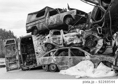 Dump of war-destroyed cars in Ukraine, black and white photo 92269544