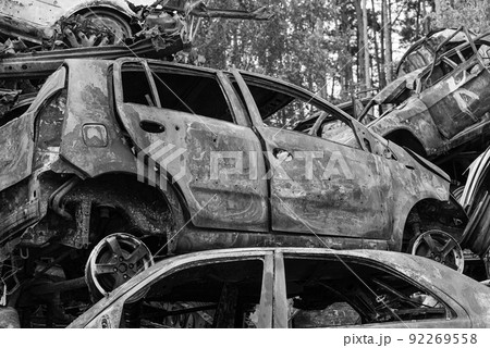 Dump of war-destroyed cars in Ukraine, black and white photo 92269558