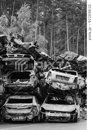 Dump of war-destroyed cars in Ukraine, black and white photo 92269610