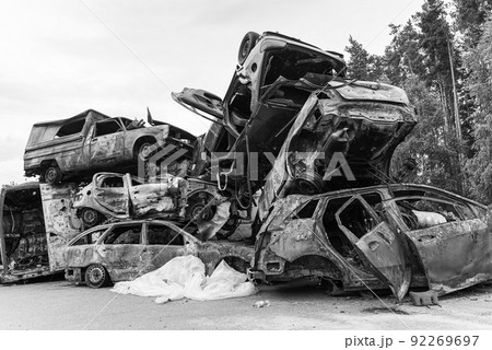 Dump of war-destroyed cars in Ukraine, black and white photo 92269697