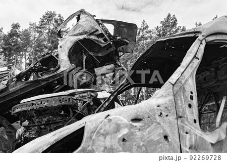Shot and burned cars during the war in Ukraine, black and white photo Shot and burned cars during the war in Ukraine, black and white photo 92269728