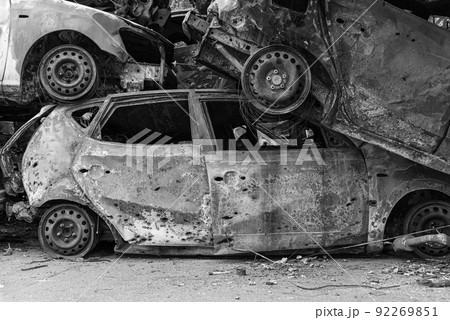 Dump of war-destroyed cars in Ukraine, black and white photo 92269851