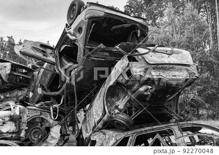 Shot and burned cars during the war in Ukraine, black and white photo 92270048