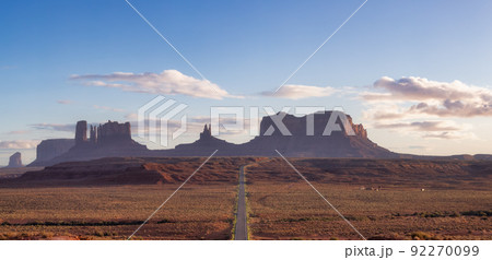 Scenic Road in the Dry Desert with Red Rocky Mountains in Background. 92270099