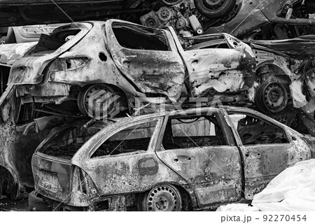 Shot and burned cars during the war in Ukraine, black and white photo 92270454