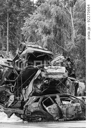 Dump of war-destroyed cars in Ukraine, black and white photo 92270664
