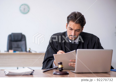 Young male judge working in the courthouse Young male judge working in the courthouse 92270732