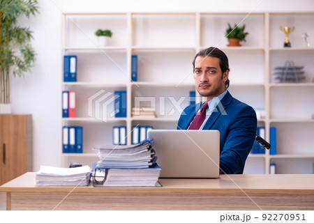 Young disabled employee working in the office Young disabled employee working in the office 92270951