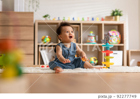 Cute Asian baby playing educational toys to learning and develop skill at home. Adorable cheerful baby toddler enjoy with toys in Nursery. Development skill in baby concept 92277749