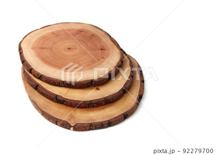 Wooden stand for a dish on a white background. A saw cut of a tree trunk to demonstrate the presentation of the product Wooden stand for a dish on a white background. A saw cut of a tree trunk to demonstrate the presentation of the product 92279700