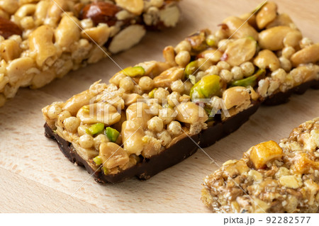 Cereal superfood energy bars with almond nuts, dry fruits, raisins chocolate on the wood table Cereal superfood energy bars with almond nuts, dry fruits, raisins chocolate on the wood table 92282577