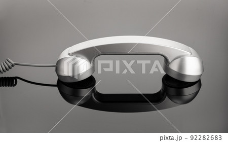 Retro telephone handset on dark background. Contact us concept Retro telephone handset on dark background. Contact us concept 92282683