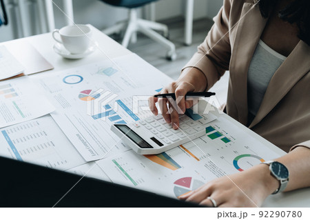Businesswoman works on analyzing financial data using a calculator with calculations. Accounting Concepts and Personal Financial Planning Businesswoman works on analyzing financial data using a calculator with calculations. Accounting Concepts and Personal Financial Planning 92290780