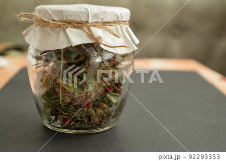glass jar filled with dried wild strawberries closed with piece of craft paper and tied with twine glass jar filled with dried wild strawberries closed with piece of craft paper and tied with twine 92293353