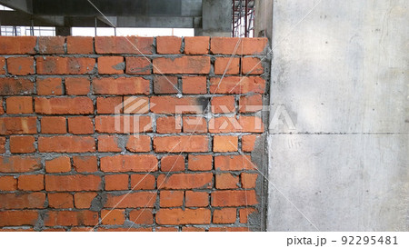 SELANGOR, MALAYSIA -MARCH 5, 2022: Brick installation works at construction sites. Bricks are installed in layers and joined with cement mortar. 92295481