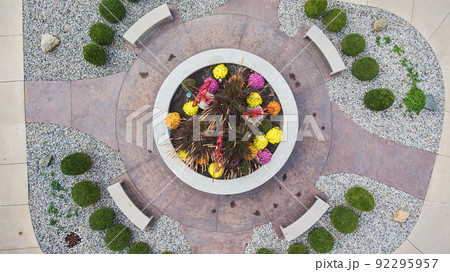 Aerial down of landscaping and walkways surrounding garden Aerial down of landscaping and walkways surrounding garden 92295957