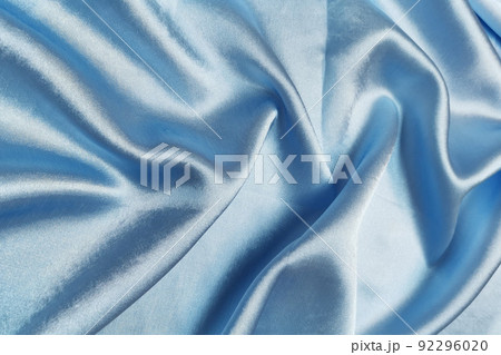 Blue crepe satin crumpled or wavy fabric texture background. Abstract linen cloth soft waves. Silk fabric. Smooth elegant luxury cloth texture. Concept for banner or advertisement. Blue crepe satin crumpled or wavy fabric texture background. Abstract linen cloth soft waves. Silk fabric. Smooth elegant luxury cloth texture. Concept for banner or advertisement. 92296020