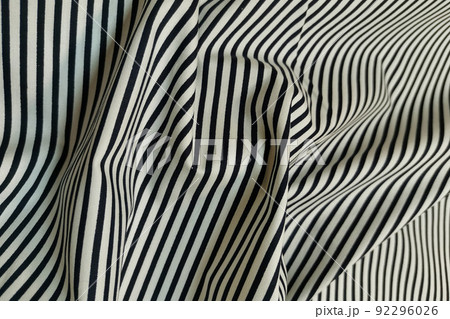 White fabric with black stripes. Crumpled or wavy fabric texture background. Abstract linen cloth soft waves. Natural yarn. Smooth elegant luxury cloth texture. Concept for banner or advertisement. 92296026