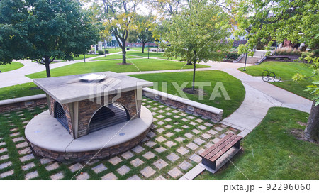 Outdoor campus firepit enclosure surrounded by trees Outdoor campus firepit enclosure surrounded by trees 92296060