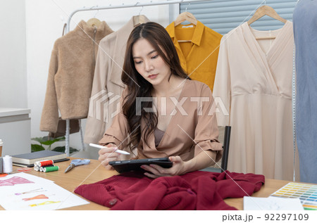 Professional female designer sketching outfits through tablet in the design studio, Fashion designer, Creativity and ideas, Mannequin, Shirt sketch, Color scheme, Garment accessories ,Freelance. Professional female designer sketching outfits through tablet in the design studio, Fashion designer, Creativity and ideas, Mannequin, Shirt sketch, Color scheme, Garment accessories ,Freelance. 92297109