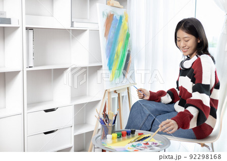 Female artist painting on canvas, Artist studio interior, Draw with watercolor, Drawing supplies , Painting and creativity, Use a brush to draw a pattern by stripes, Artwork, Using Paint Brush. Female artist painting on canvas, Artist studio interior, Draw with watercolor, Drawing supplies , Painting and creativity, Use a brush to draw a pattern by stripes, Artwork, Using Paint Brush. 92298168