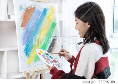 Female artist painting on canvas, Artist studio interior, Draw with watercolor, Drawing supplies , Painting and creativity, Use a brush to draw a pattern by stripes, Artwork, Using Paint Brush. Female artist painting on canvas, Artist studio interior, Draw with watercolor, Drawing supplies , Painting and creativity, Use a brush to draw a pattern by stripes, Artwork, Using Paint Brush. 92298169