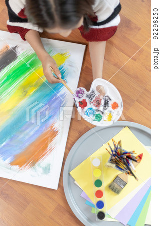 Female artist painting on canvas, Artist studio interior, Draw with watercolor, Drawing supplies , Painting and creativity, Use a brush to draw a pattern by stripes, Artwork, Using Paint Brush. 92298250