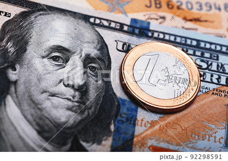 Euro coin on US Dollar bills, currency exchange rate concept 92298591