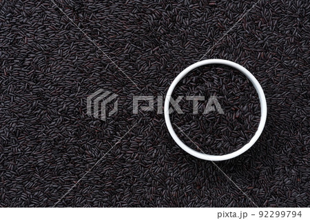 ceramic plate with black rice on a thai black rice background close-up top view. ceramic plate with black rice on a thai black rice background close-up top view. 92299794