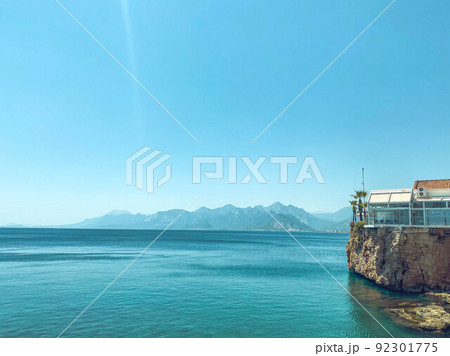 clear, blue water of the sea. a yacht with tourists floats on the water. next to the sea are high mountains. rest in a hot country by the water. swimming in the sea clear, blue water of the sea. a yacht with tourists floats on the water. next to the sea are high mountains. rest in a hot country by the water. swimming in the sea 92301775
