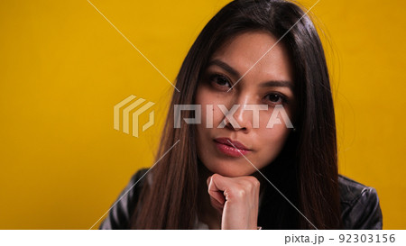 Portrait of a young beautiful woman against a neutral background 92303156