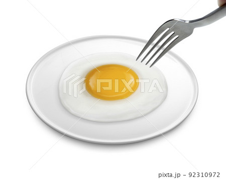 A man's hand holds a fork. fried egg on the plate a isolated white background A man's hand holds a fork. fried egg on the plate a isolated white background 92310972