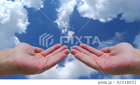 Two open hands of young Asian man sky and clouds background with copy space 92318031